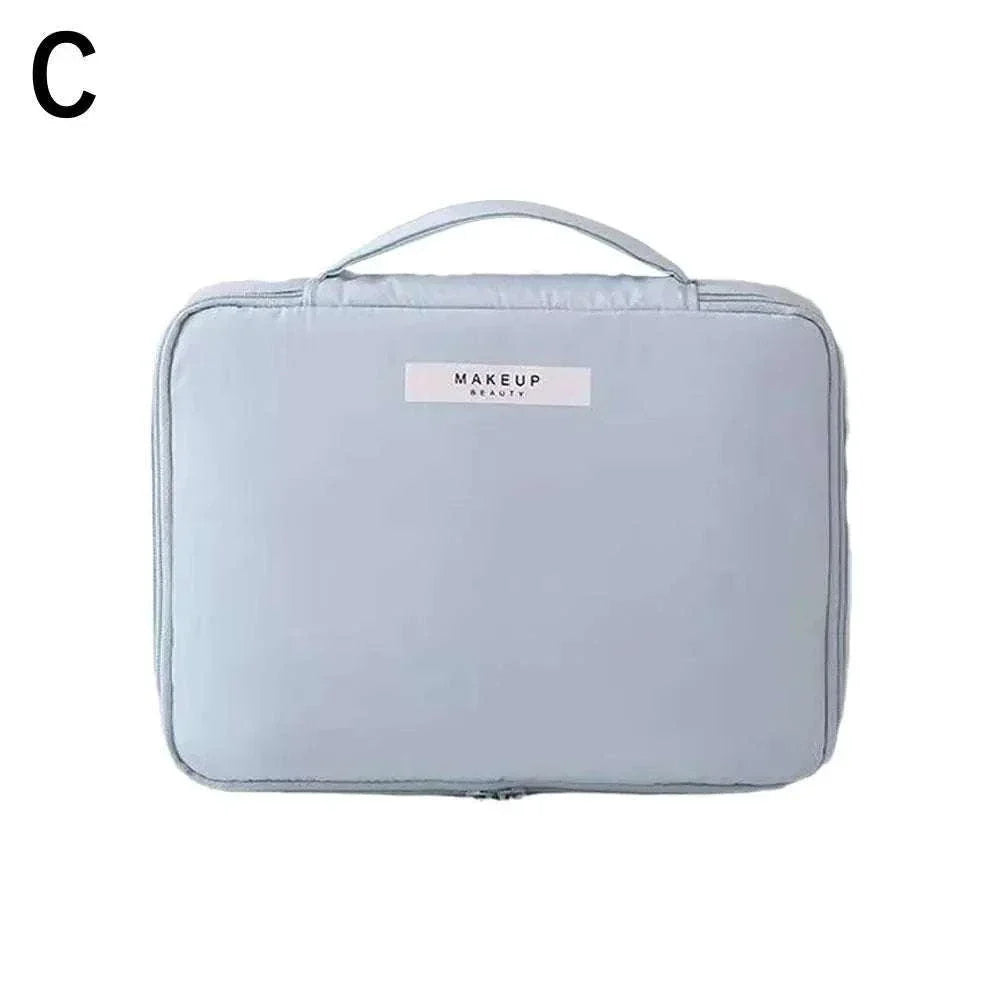 Waterproof portable cosmetic bag in light blue for toiletries and makeup storage.