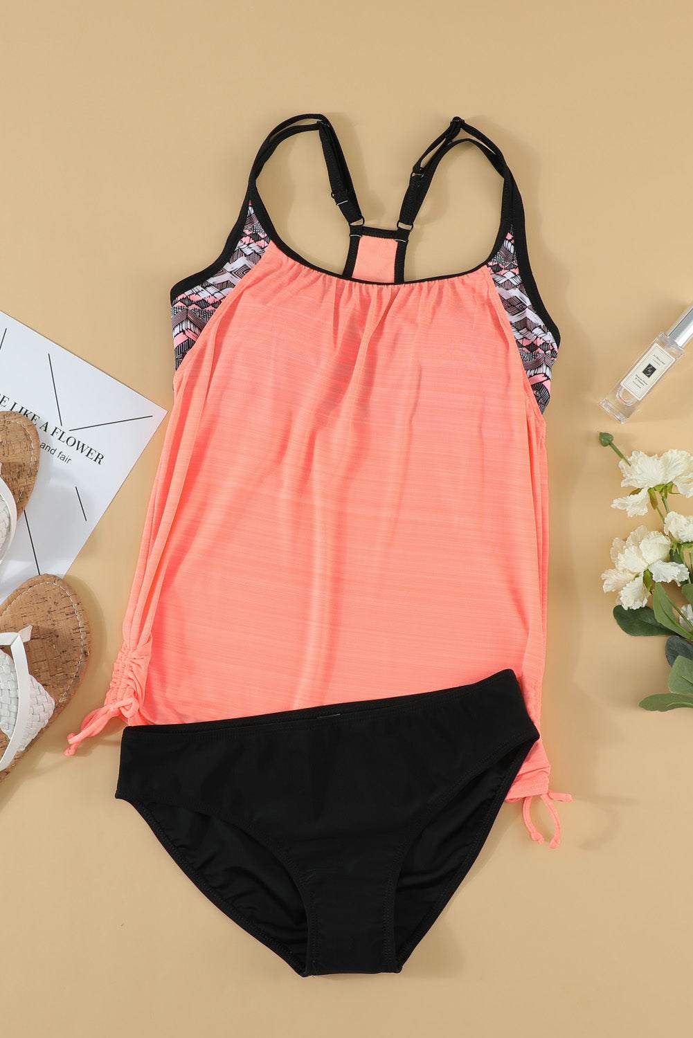 Two-piece swim set with scoop neck top and briefs in coral and black.