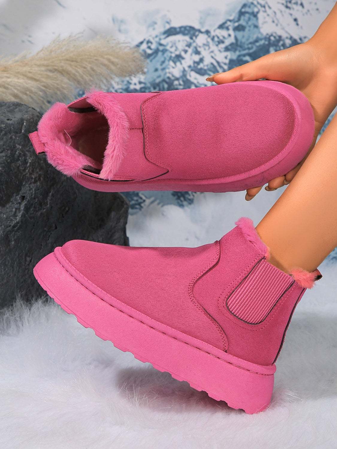 Pink suede round toe platform boots with faux fur trim and rubber soles.