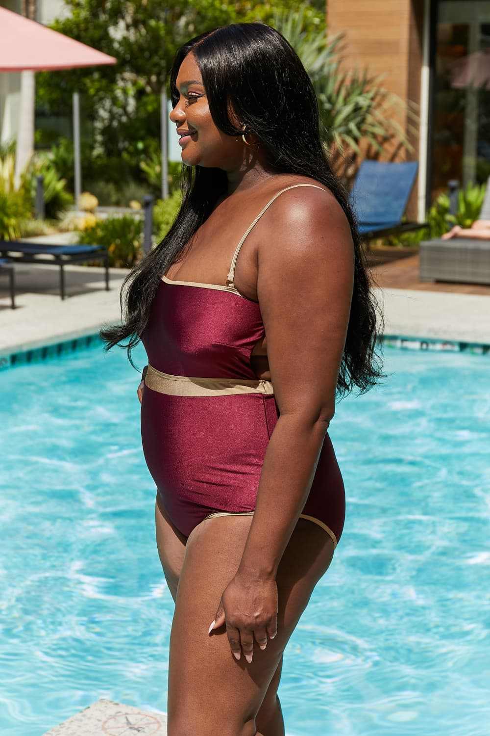 Marina West Swim Wave Break Contrast Trim one-piece swimsuit in wine by poolside.