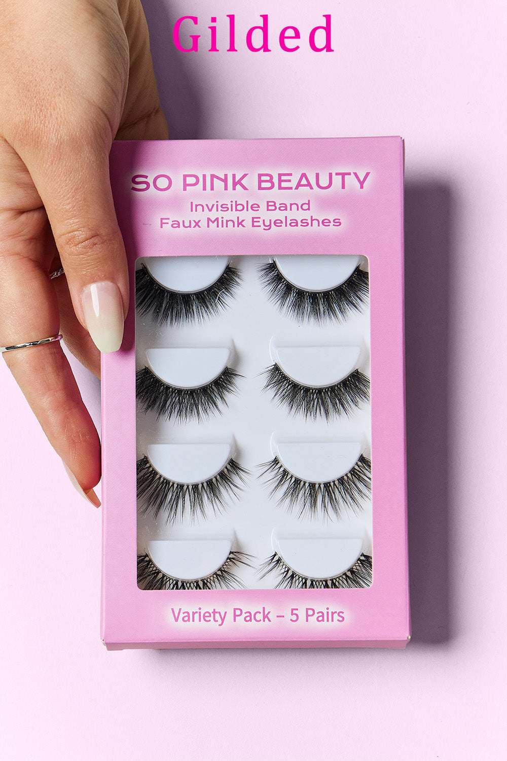 SO PINK BEAUTY Faux Mink Eyelashes Variety Pack 5 Pairs in packaging with hand holding the pink box.