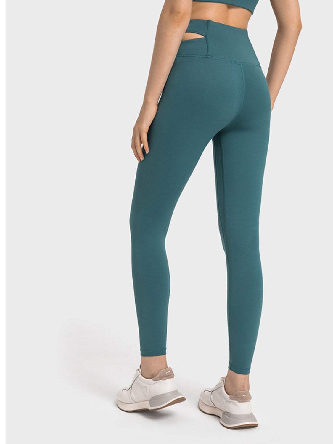 Millennia Crisscross Cutout Sports Leggings in teal, stretchy nylon and spandex blend, back view.