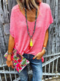 Full-size scoop neck short sleeve t-shirt in bright pink, paired with blue jeans and colorful accessories.