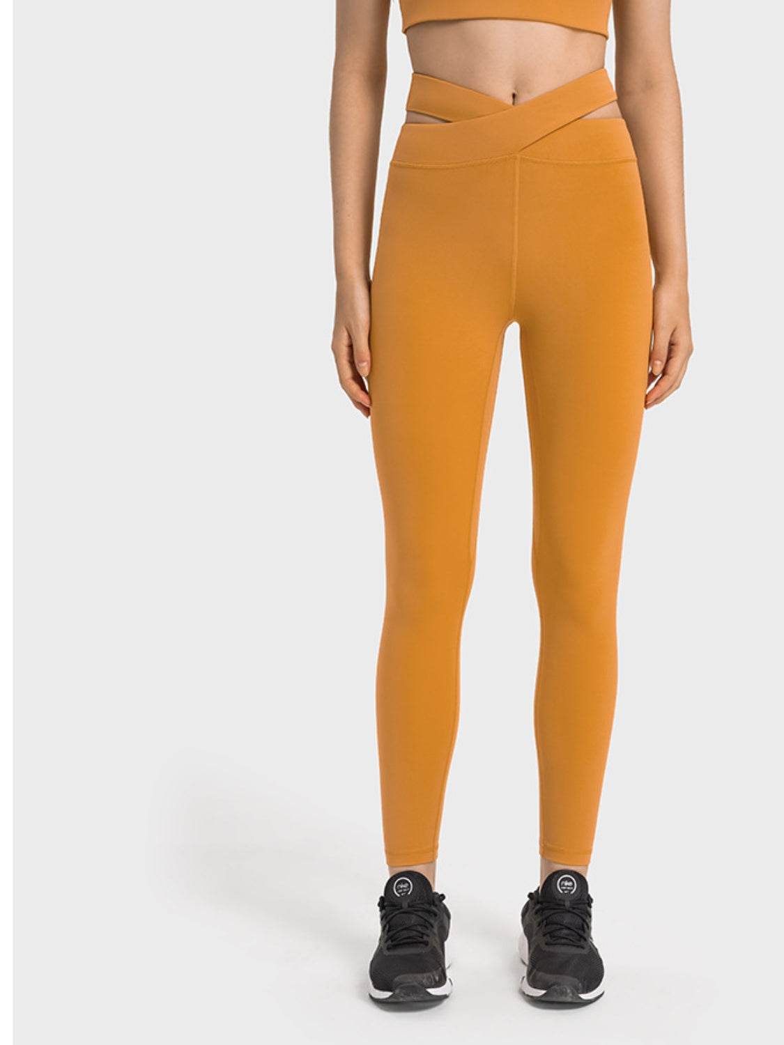 Millennia Crisscross Cutout Sports Leggings in mustard color, stretchy nylon-spandex blend, front view.