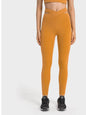 Millennia Crisscross Cutout Sports Leggings in mustard color, stretchy nylon-spandex blend, front view.