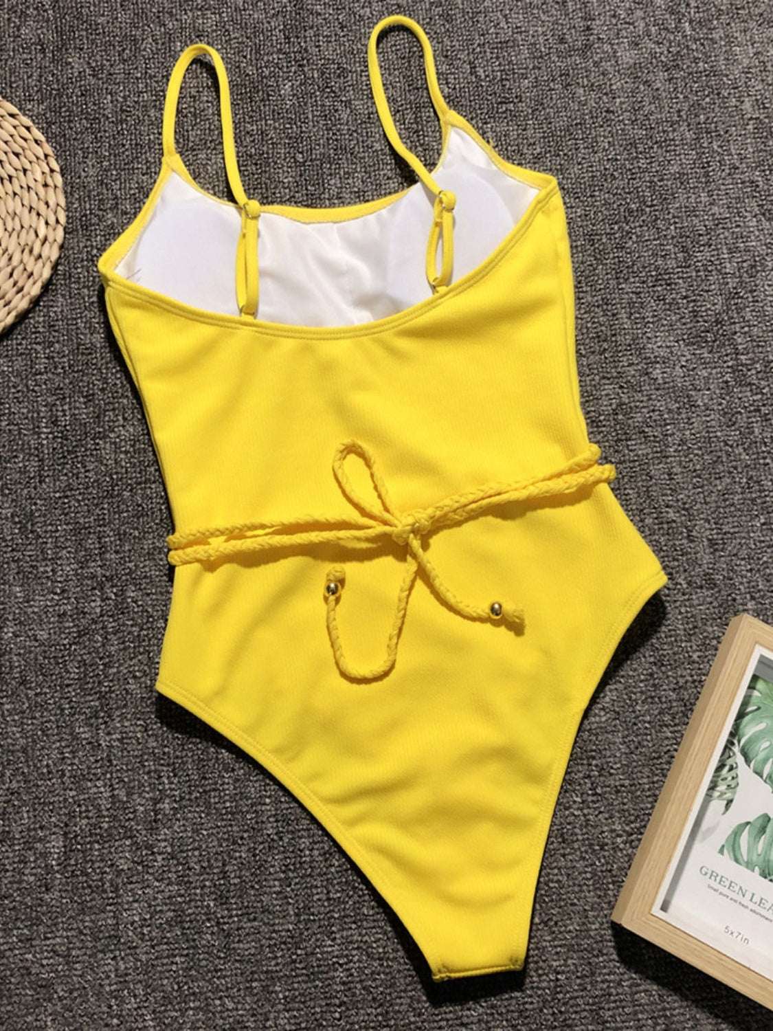 Yellow ribbed one-piece swimsuit with tie waist.