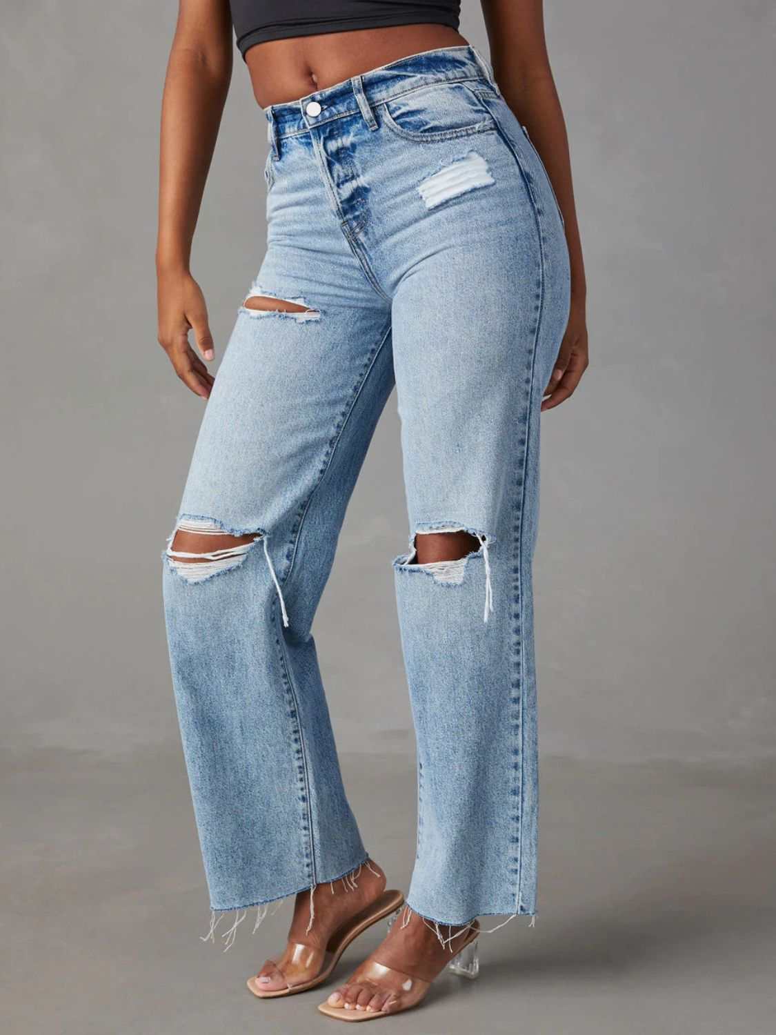 Distressed straight leg jeans with pockets and button closure, made from cotton and polyester.