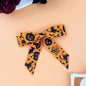 2-piece polyester bow hair clip with Halloween motifs, 4.3 x 3.9 inches, orange and black design.