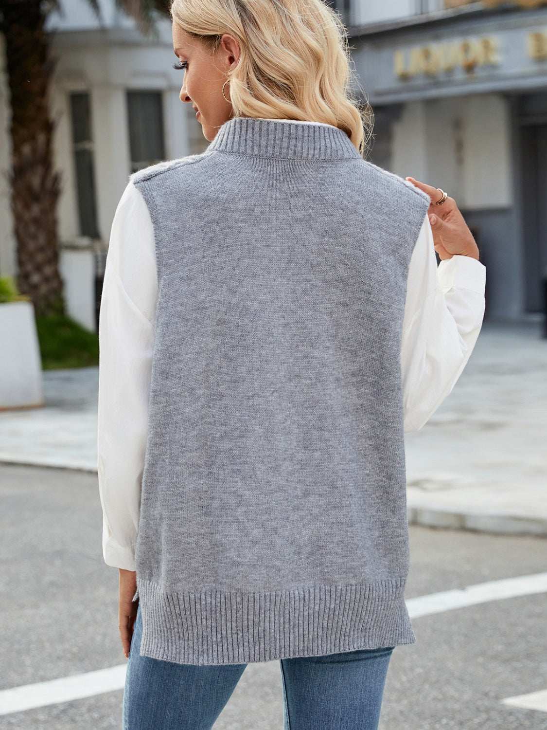 Cable knit V-neck sweater vest in gray, 100% acrylic, slightly stretchy fabric.