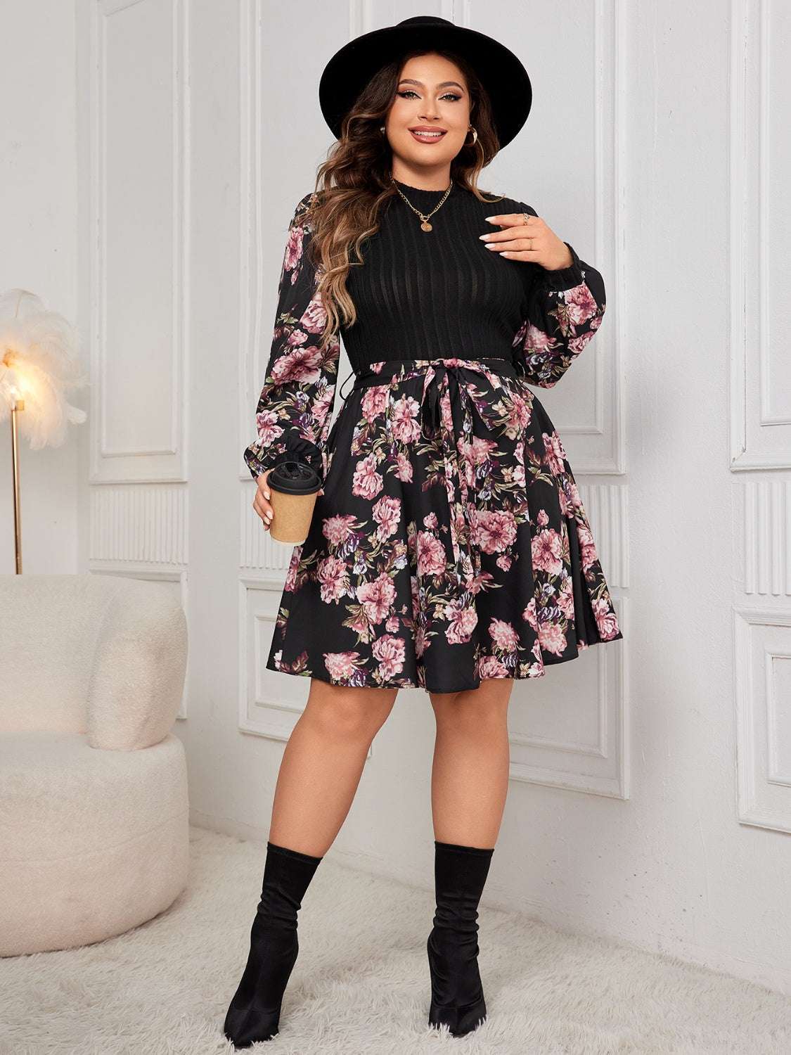 Plus size tied printed long sleeve dress with floral pattern.