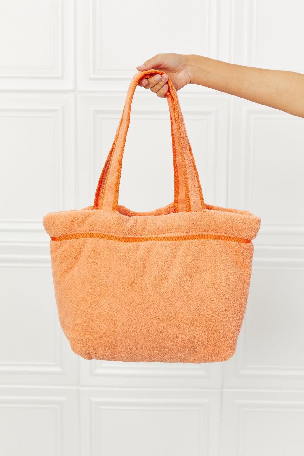 Orange plush Paradise Tote Bag, large size, with zip and slip pockets, made of 100% polyester.