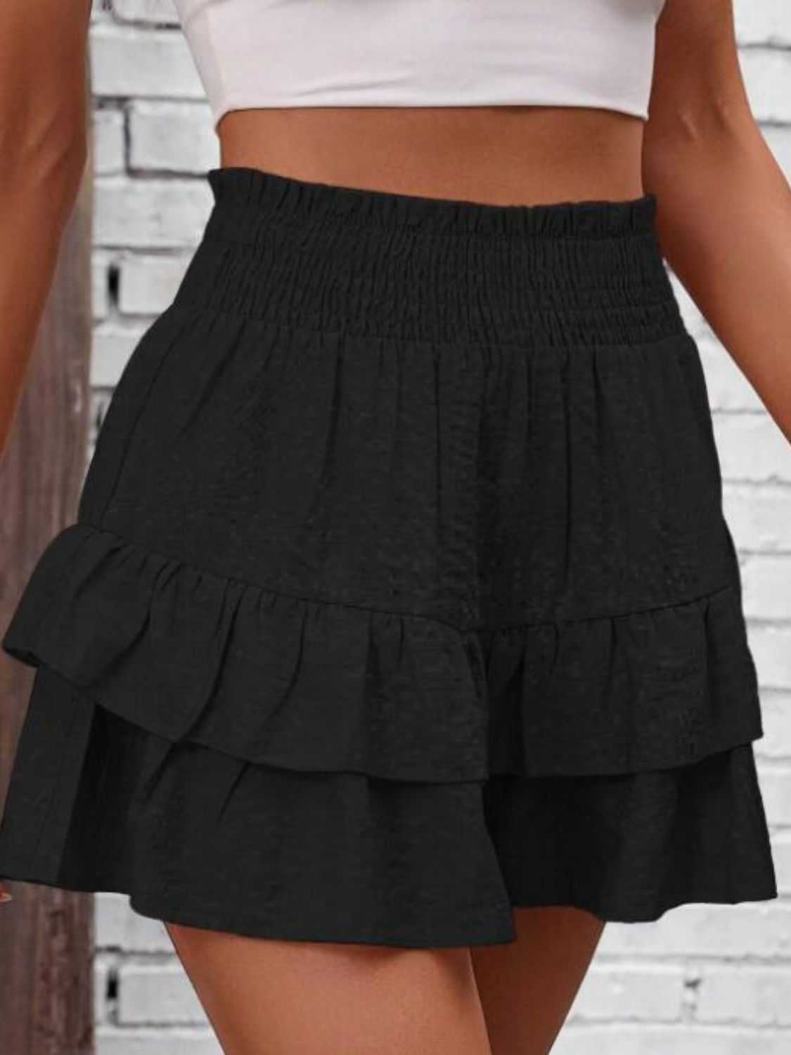 Smocked layered shorts with ruffled design in black polyester.