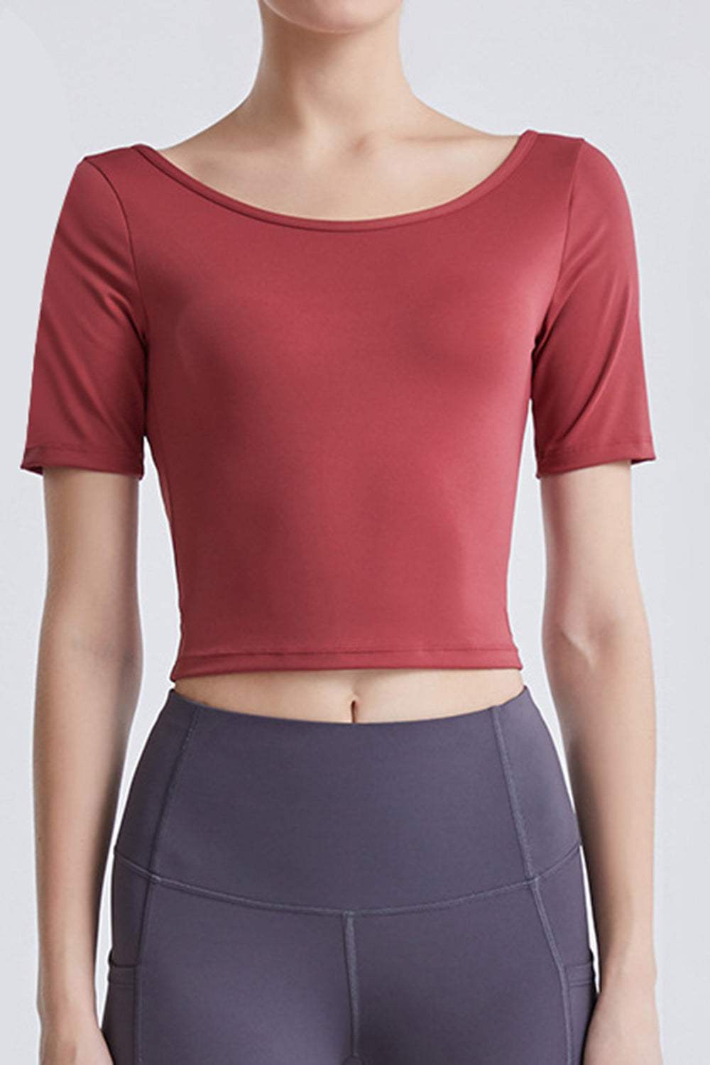 Backless round neck active T-shirt with cutout detail in red, highly stretchy fabric.