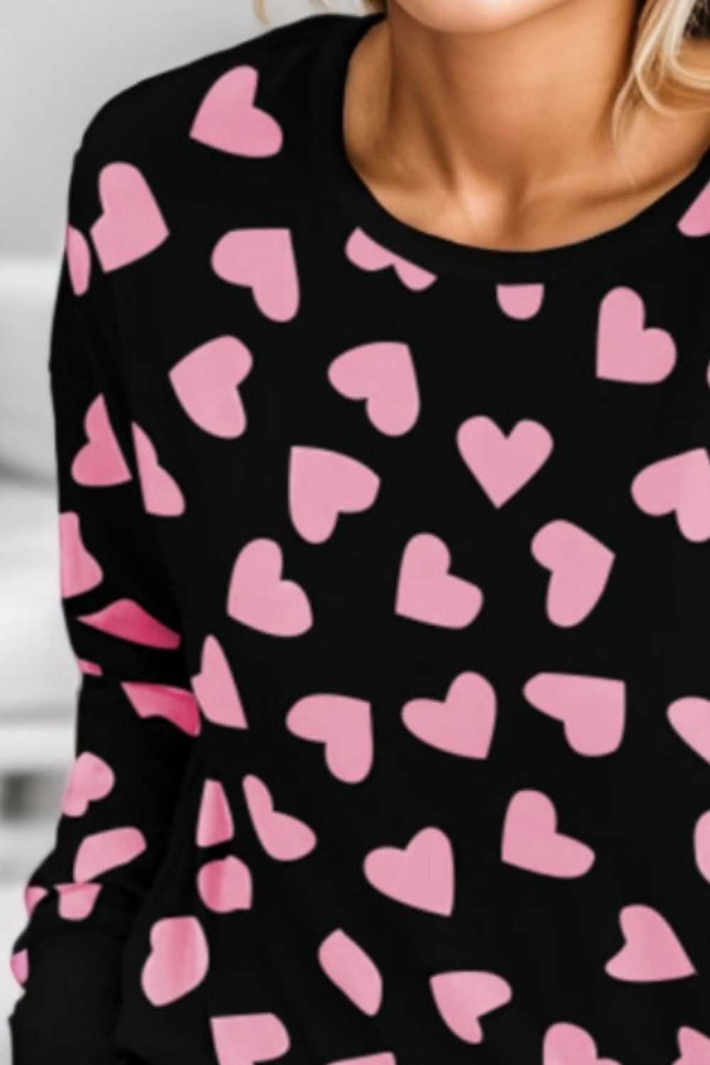 Heart print round neck top and shorts lounge set with pink hearts on black fabric.