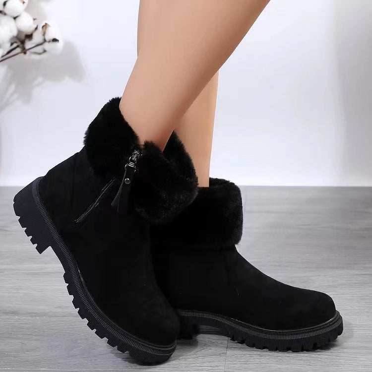 Suede faux fur boots with side zipper and low heels.