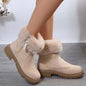 Suede faux fur boots with side zipper and low heels.