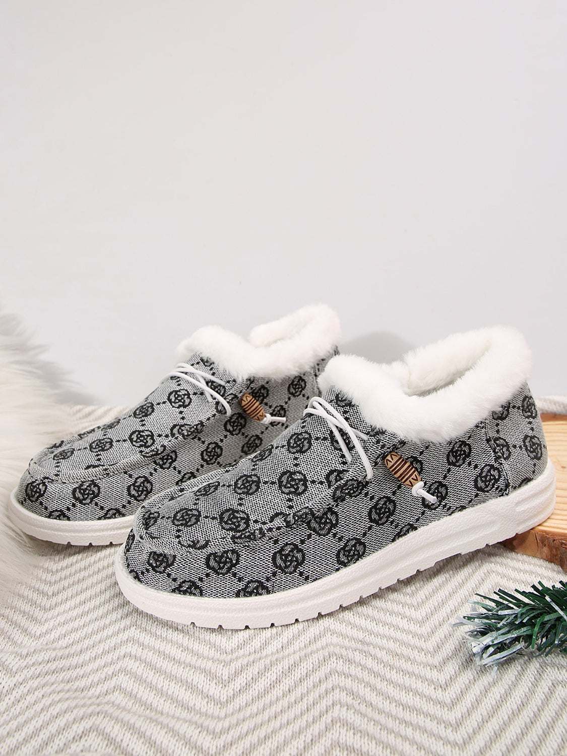 Printed round toe flat slip-ons with faux fur and cotton material.