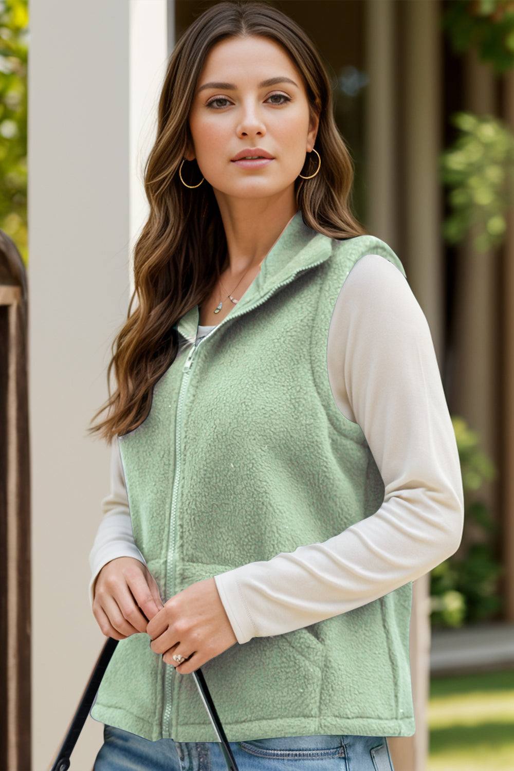 Green zip-up vest coat with pockets, made of 95% polyester and 5% spandex.