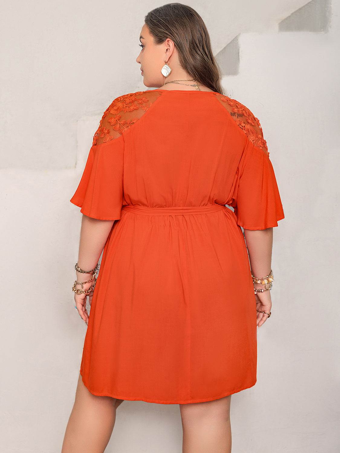 Plus size lace button up half sleeve dress in orange, featuring tied waist and semi-sheer lace details.