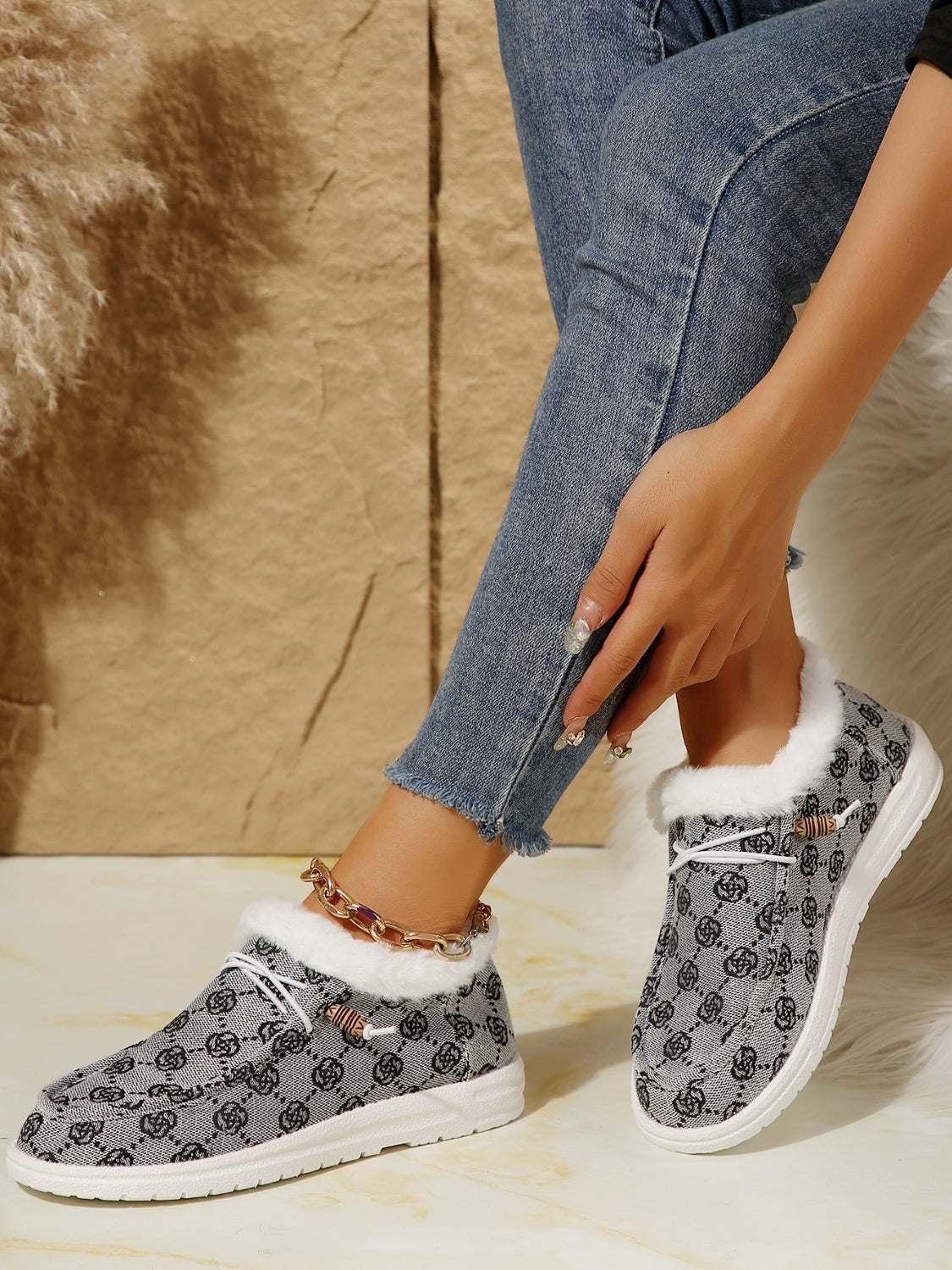 Printed round toe flat slip-ons with faux fur and cotton, worn with jeans.