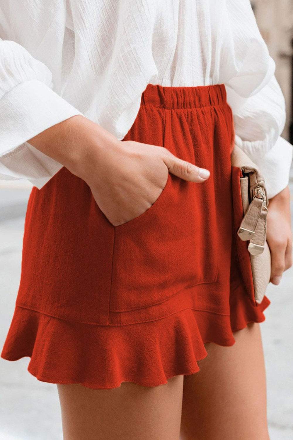 Red full size ruffled elastic waist shorts with pocket and flared hem.