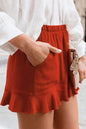 Red full size ruffled elastic waist shorts with pocket and flared hem.