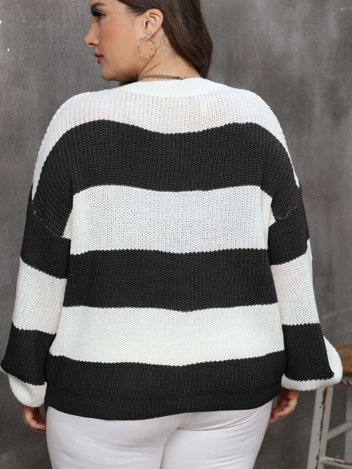 Plus size striped round neck long sleeve sweater in black and white.