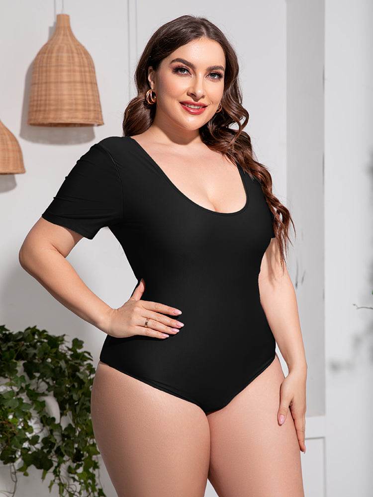 Plus size scoop neck short sleeve one-piece swimsuit in black, stretchy polyester-spandex blend, beach style.