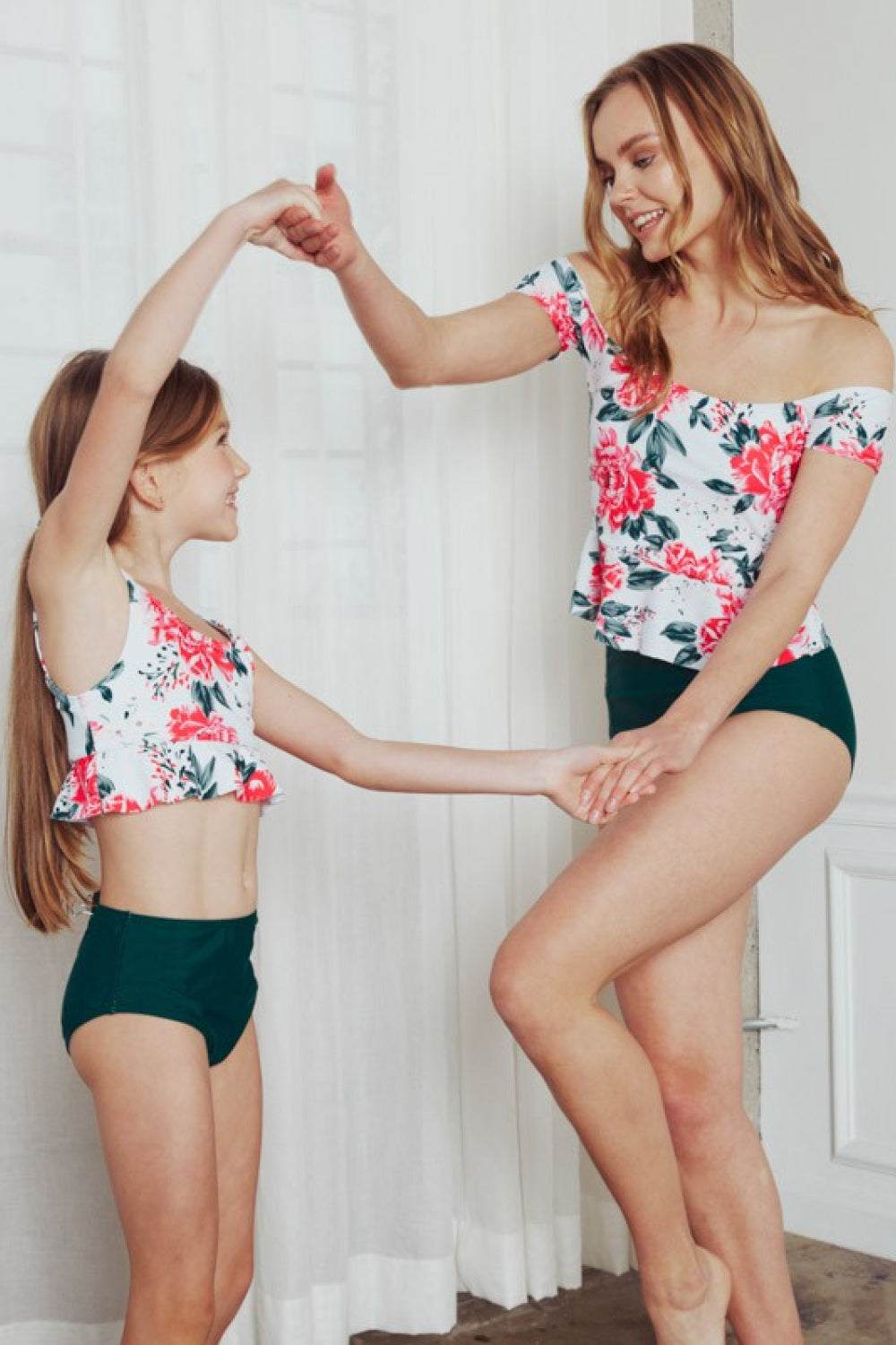 Mother and daughter in floral Marina West Swim Coastal Cutie Tankini Swimsuit Set, featuring a chic tankini top and high-waisted bottoms.