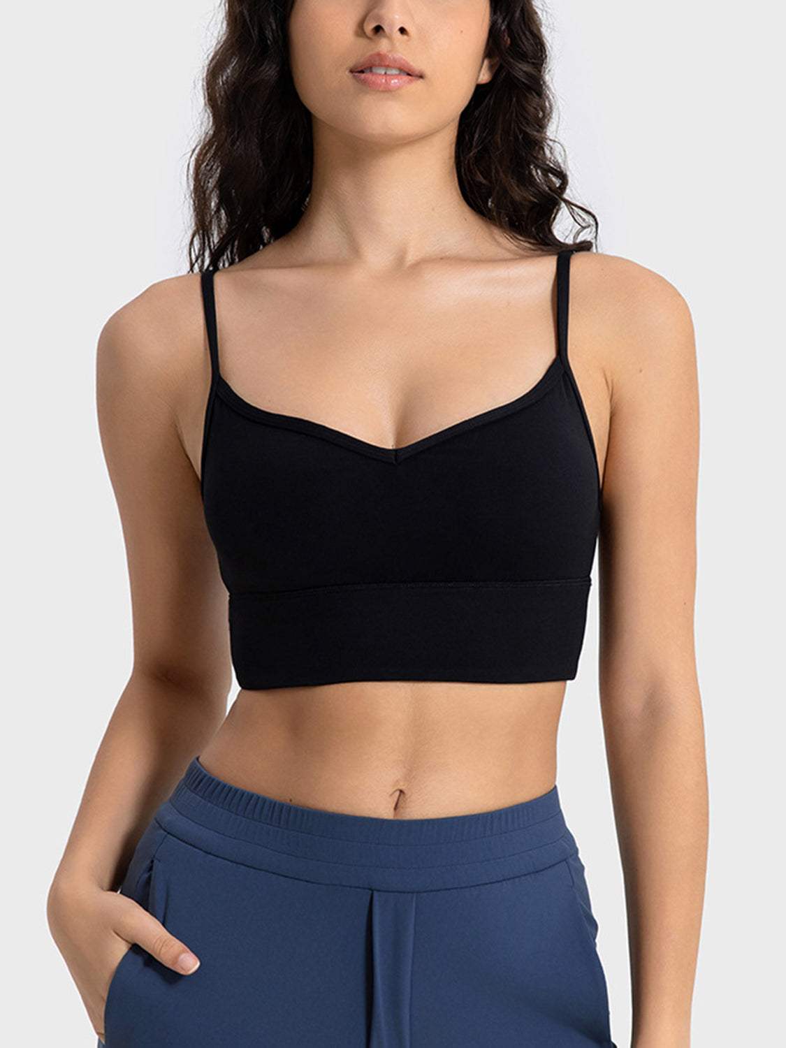 Millennia Spaghetti Strap Sport Bra in black, featuring removable padding and stretchy nylon-spandex blend.