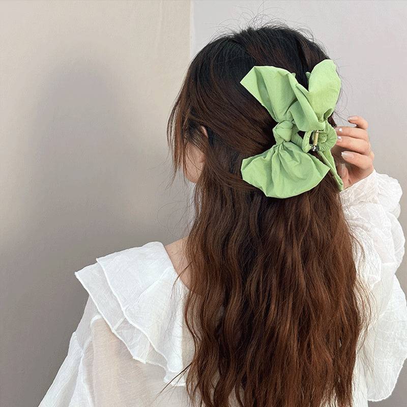 Bow Hair Claw Clip in green polyester, 5.1 inches long, on a woman's hair.