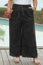 Plus size drawstring wide leg pants in black, 100% cotton, featuring large front pockets.