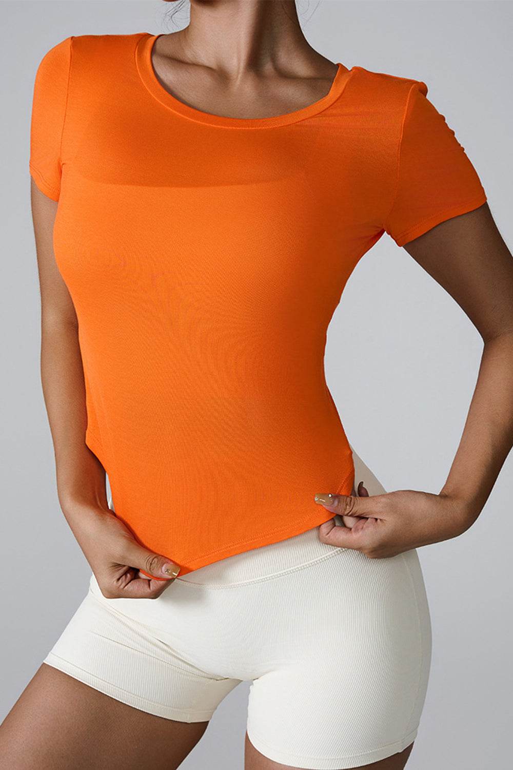 Orange cutout round neck short sleeve active t-shirt on model.