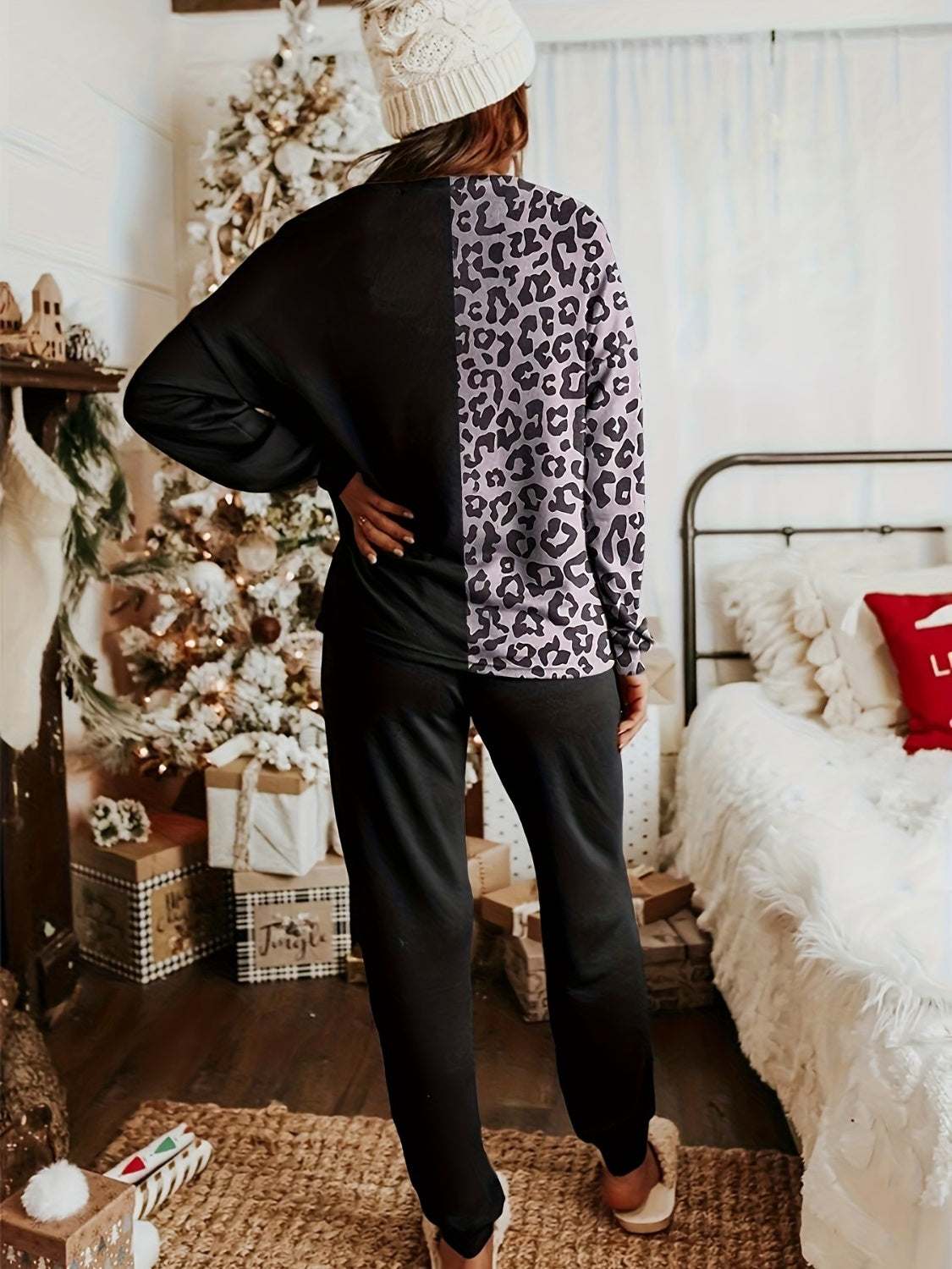 Leopard round neck sweatshirt and pants lounge set in bedroom setting.