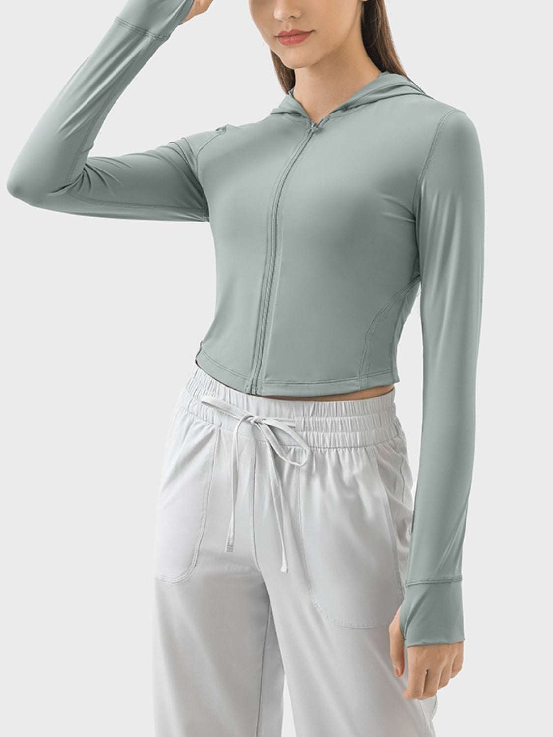 Light green zip-up hooded long sleeve active outerwear, made of nylon and spandex.