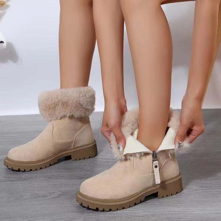 Suede faux fur boots with side zipper and low heels.