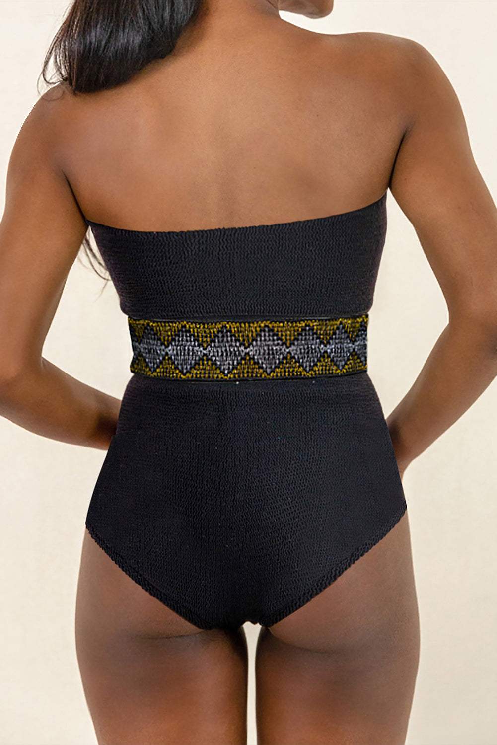 Geometric Tube Sleeveless One-Piece Swimwear with patterned waistband, featuring removable padding and stretchy polyester-elastane fabric.