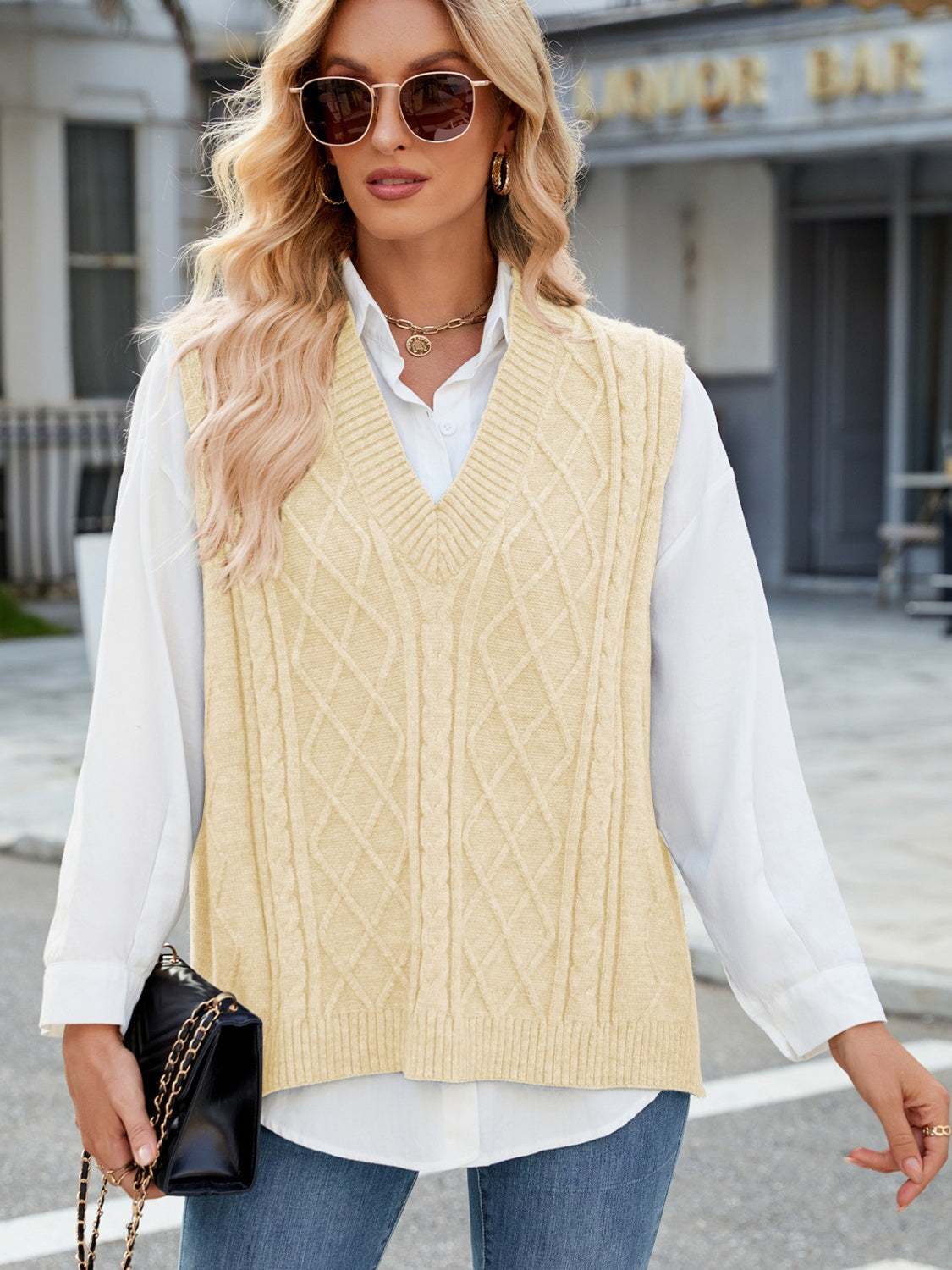 Cable Knit V-Neck Sweater Vest in cream color worn over white shirt and jeans.