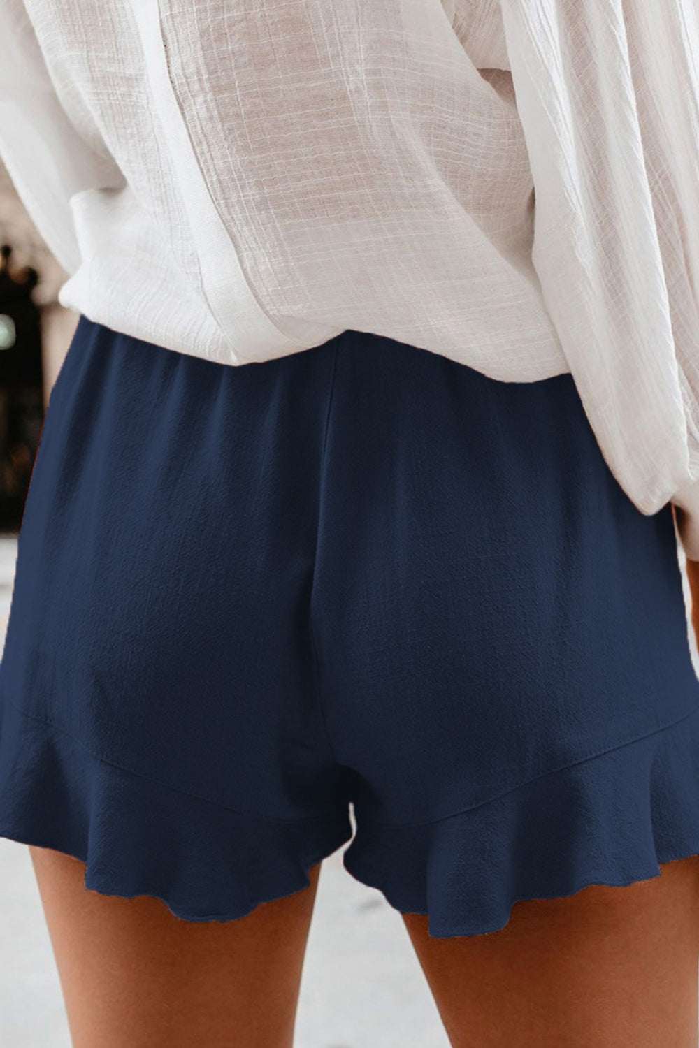 Full Size Ruffled Elastic Waist Shorts in navy blue, made from polyester and spandex.