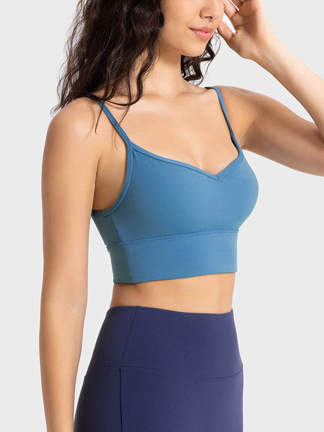 Millennia Spaghetti Strap Sport Bra in blue with removable padding and stretchy material.