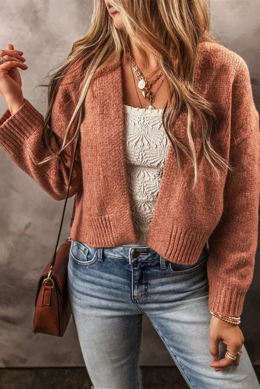 Open front dropped shoulder cardigan in brown paired with jeans and lace top.