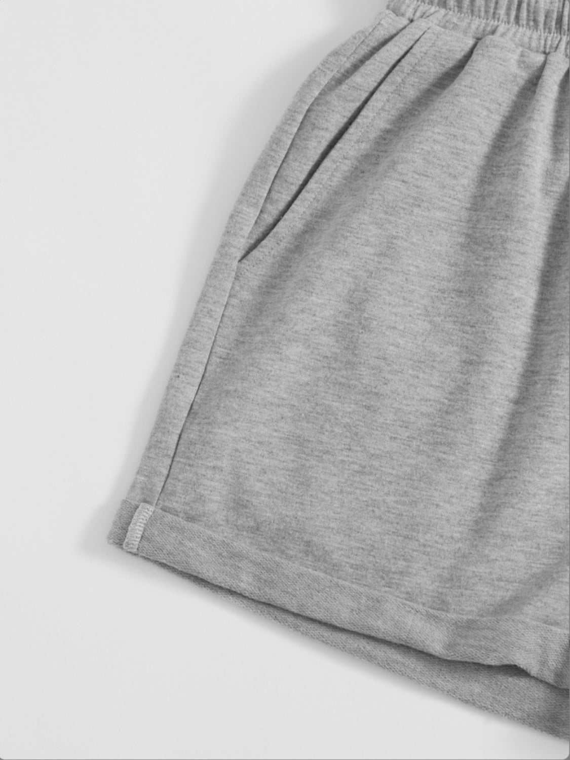 Gray drawstring pocketed elastic waist shorts made of polyester.