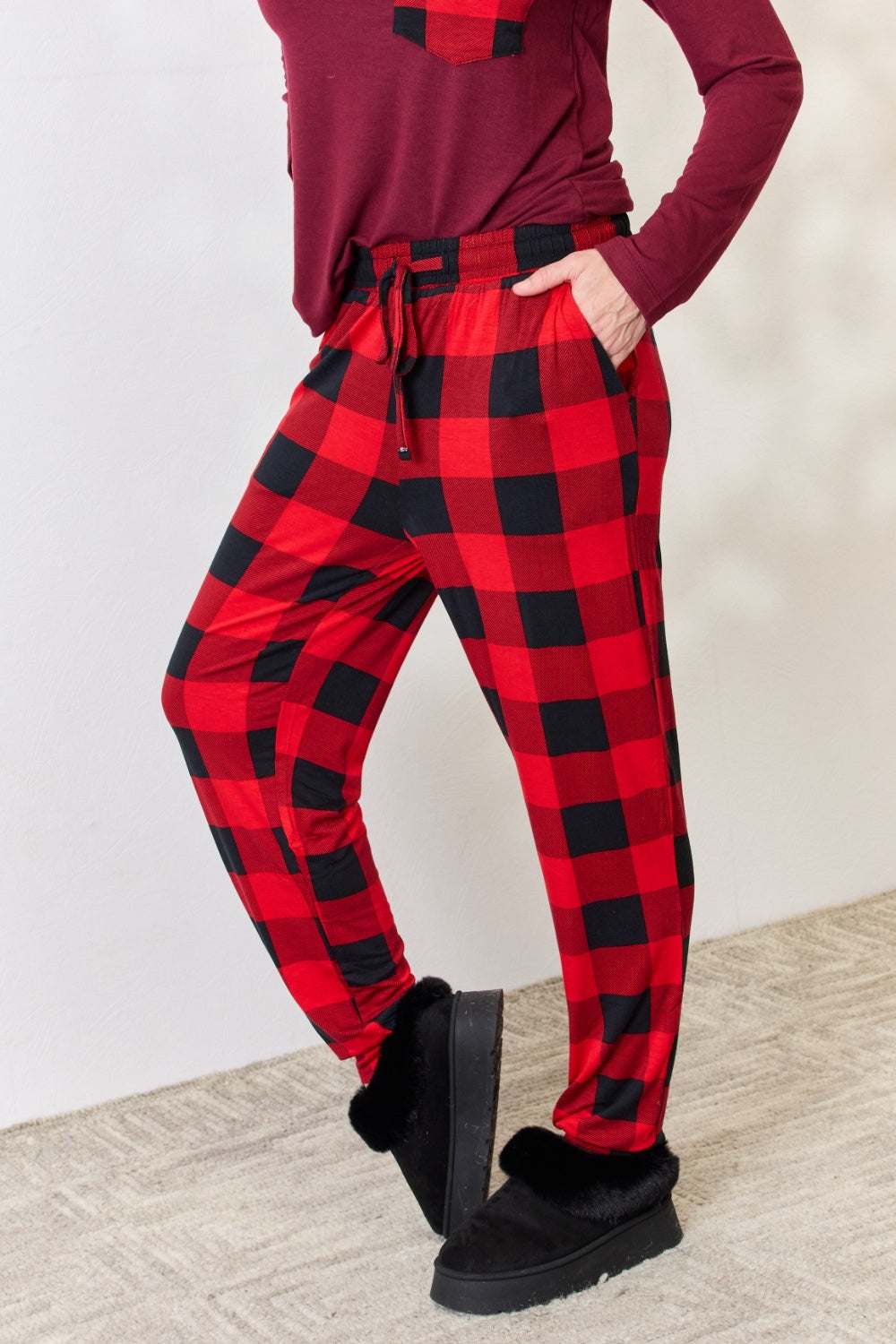 Zenana full size plaid round neck top and pants pajama set with front pocket and drawstring waist.