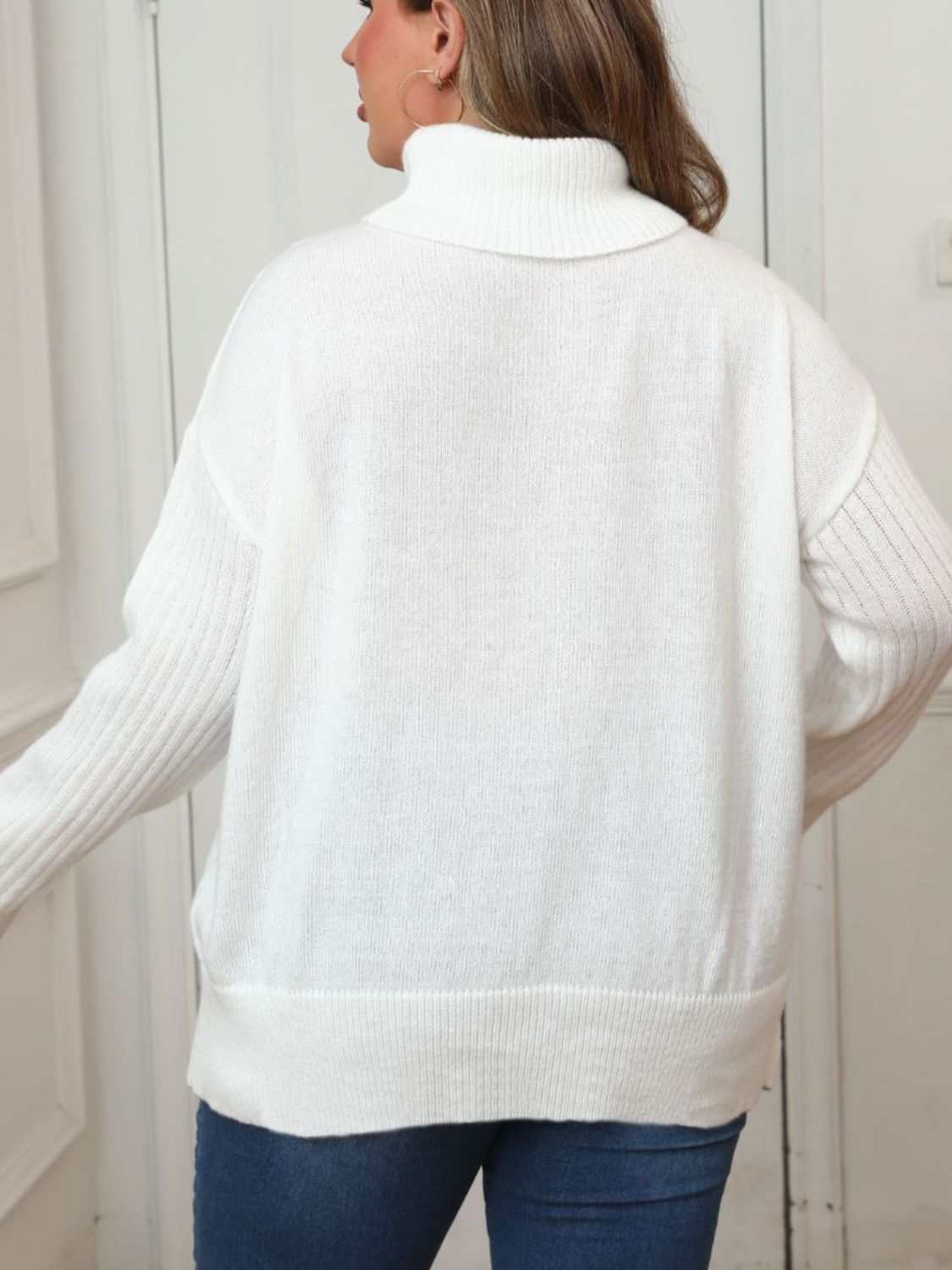 Plus size white turtleneck long sleeve sweater with moderate stretch and buttoned design.