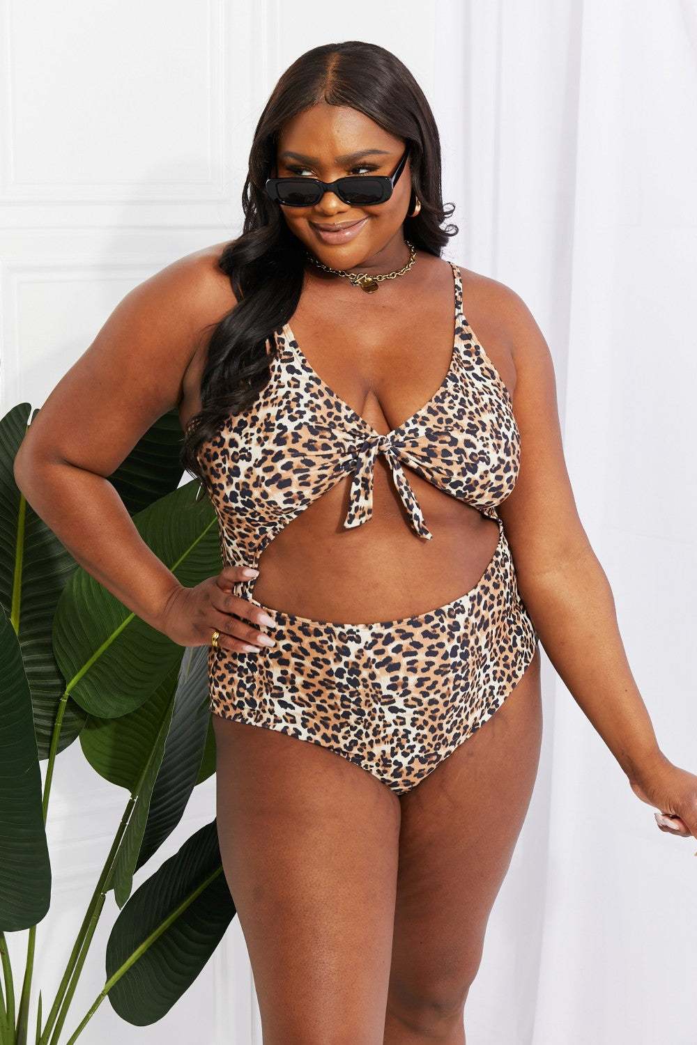 Leopard print cutout one-piece swimsuit with plunging neckline by Marina West Swim.