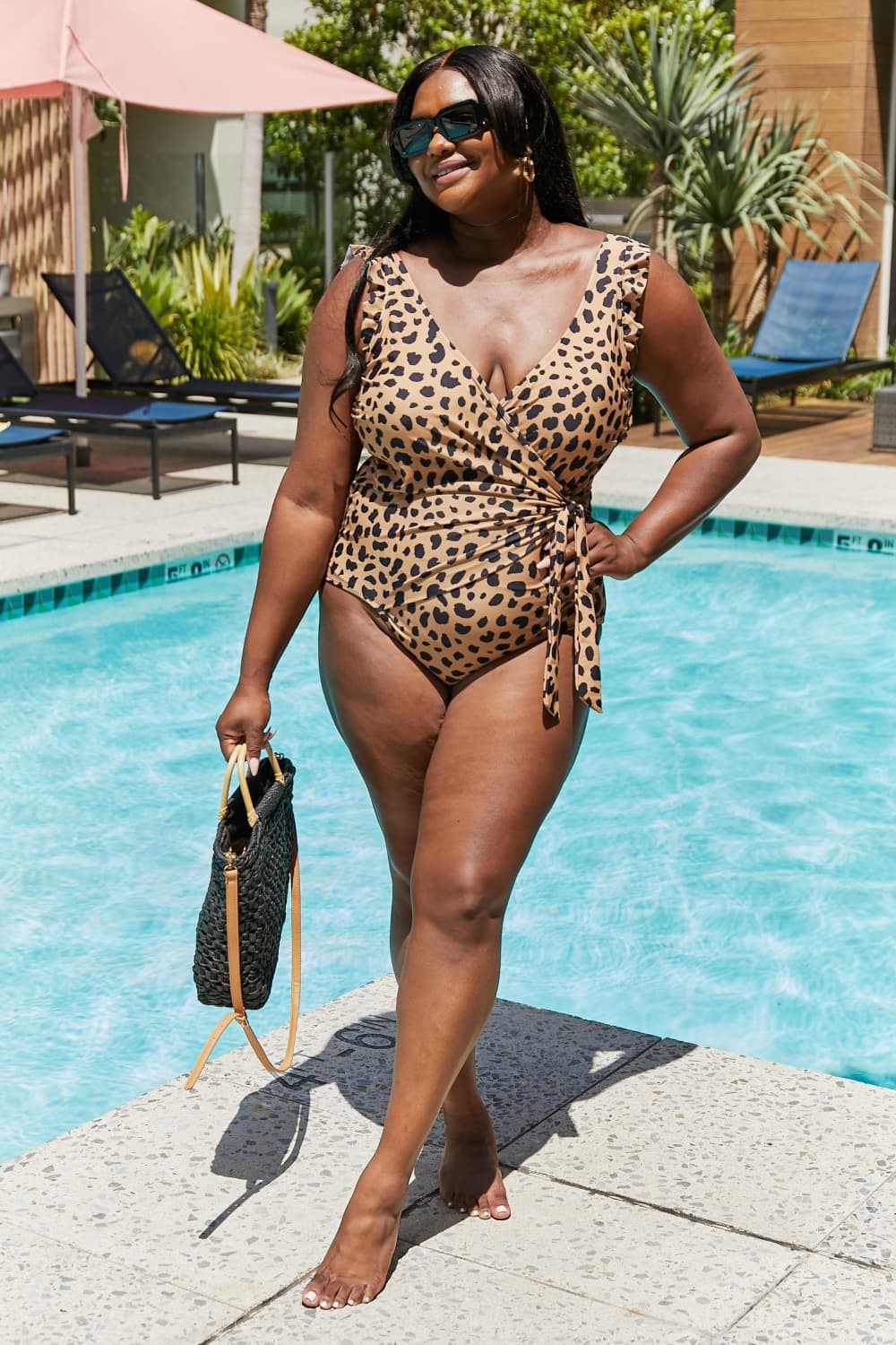 Leopard print one-piece swimsuit with ruffle faux wrap design by Marina West Swim.