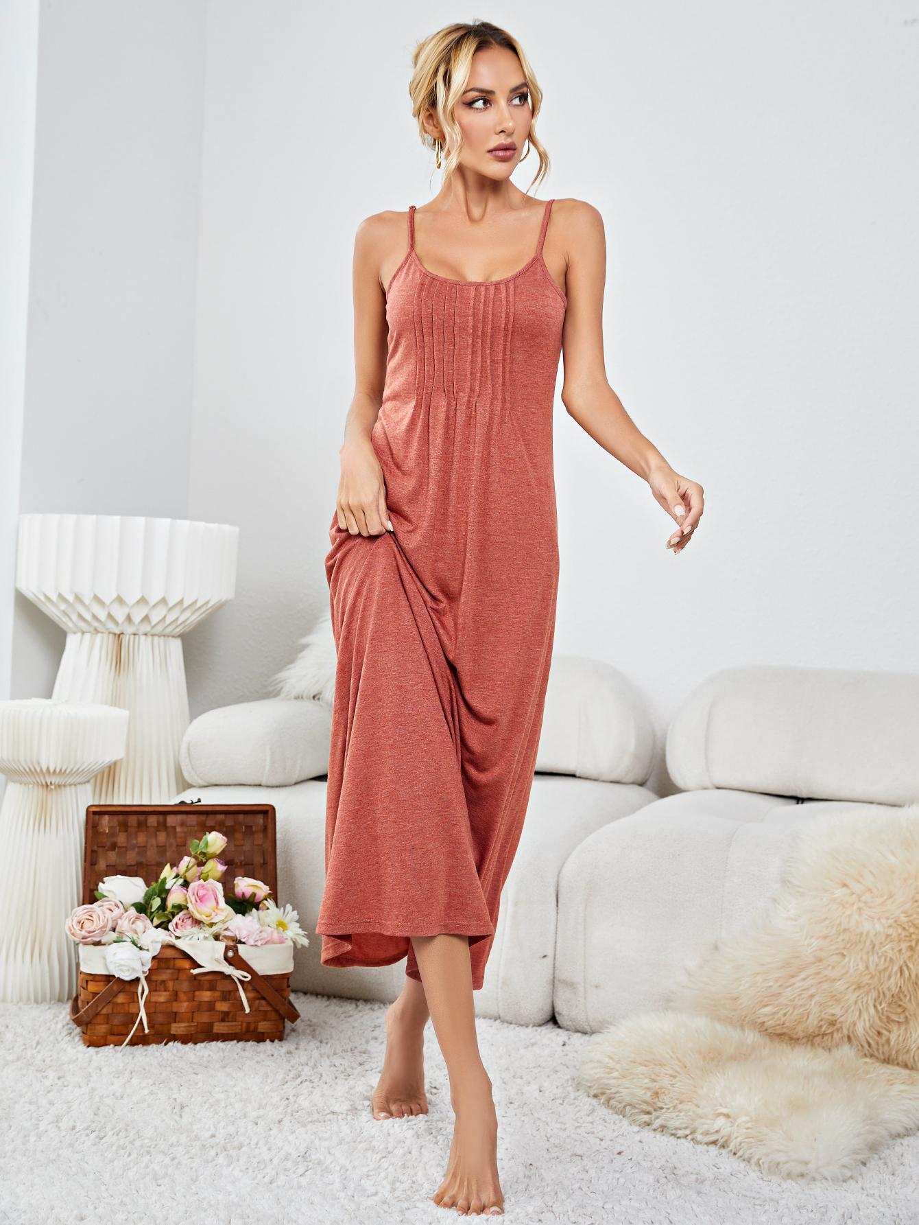 Minimalist scoop neck spaghetti strap night dress in solid color, sleeveless design, studio setting.