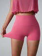 High Waist Active Shorts in pink, pocketed, highly stretchy nylon-spandex blend.