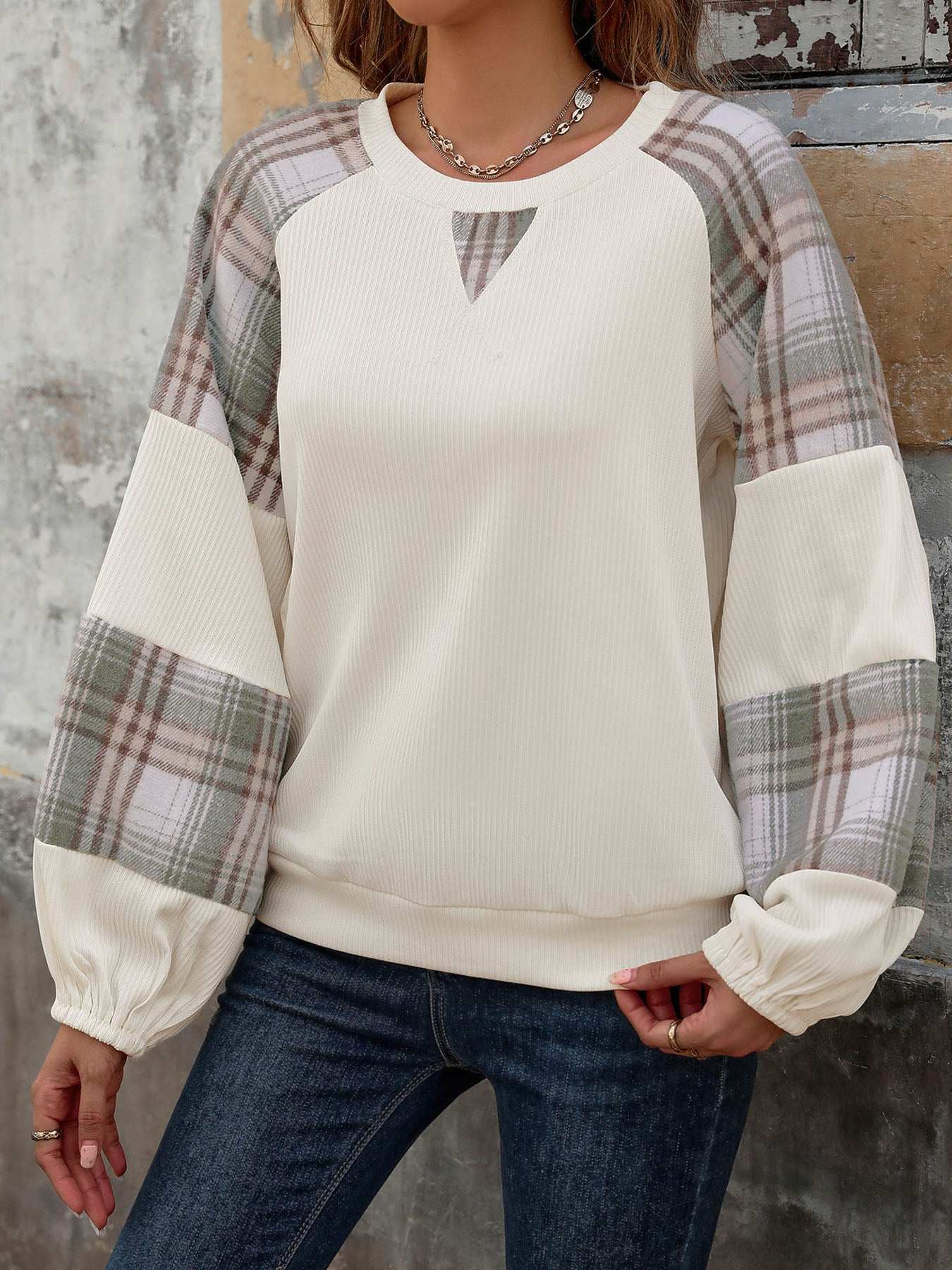 Perfee Plaid Round Neck Long Sleeve Sweatshirt featuring plaid sleeves and ribbed cuffs.