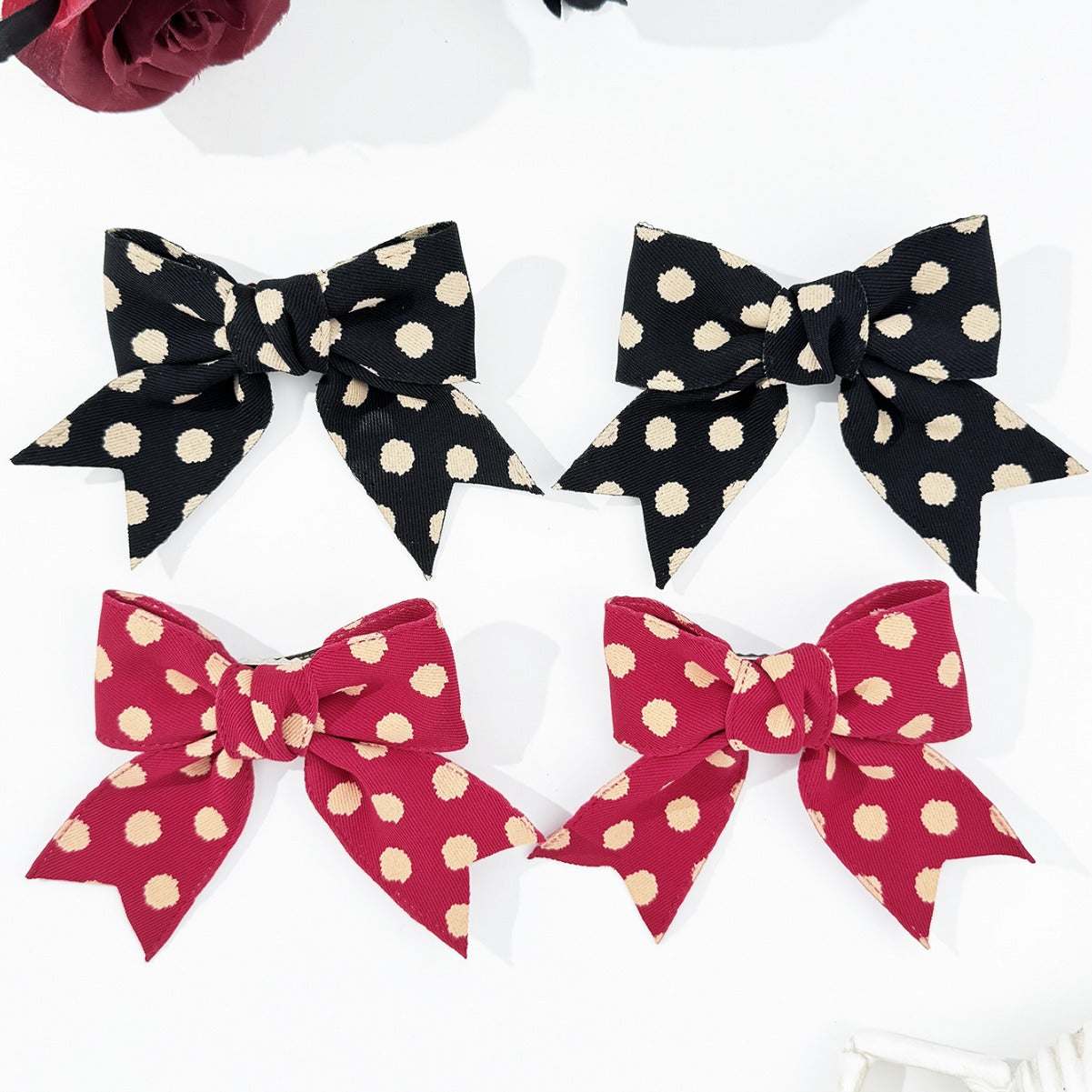 2-Piece Polka Dot Bow Hair Clip in black and red, polyester material.